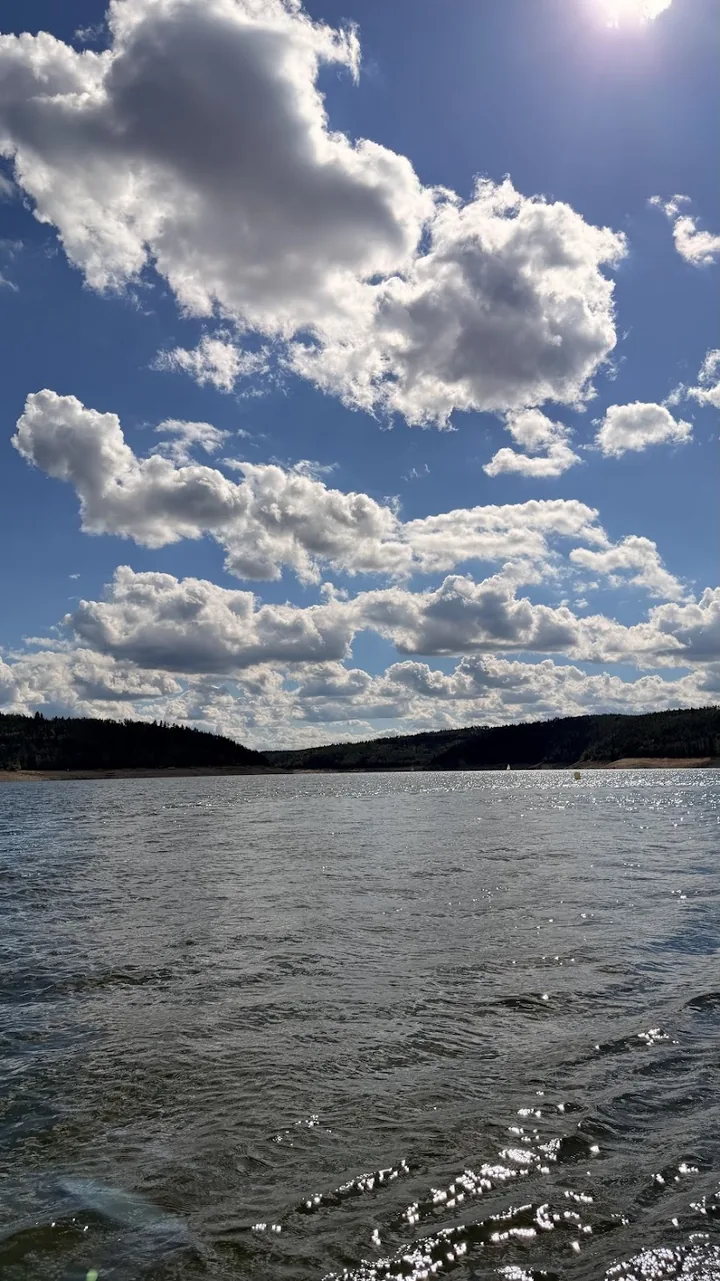 Sunlight on Orlík beneath a cloudy sky